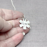 EMS necklace in hand to show size