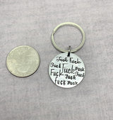 Fuck keychain, swear keychain, All the fucks keychain next to quarter for size comparison