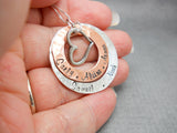 Sterling Silver and Copper Personalized Mothers Necklace with Kids Names and Heart Charm, held in hand