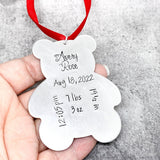 Baby's first Christmas ornament show in hand