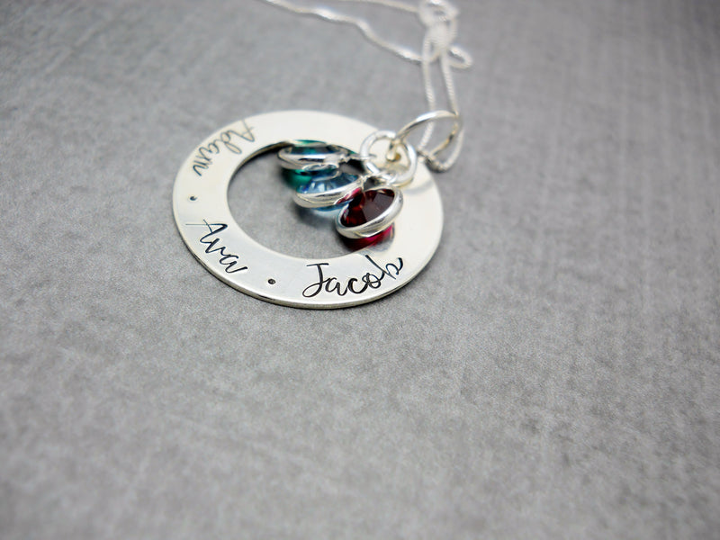 Sterling silver personalized Mothers washer necklace with kids names, flat lay