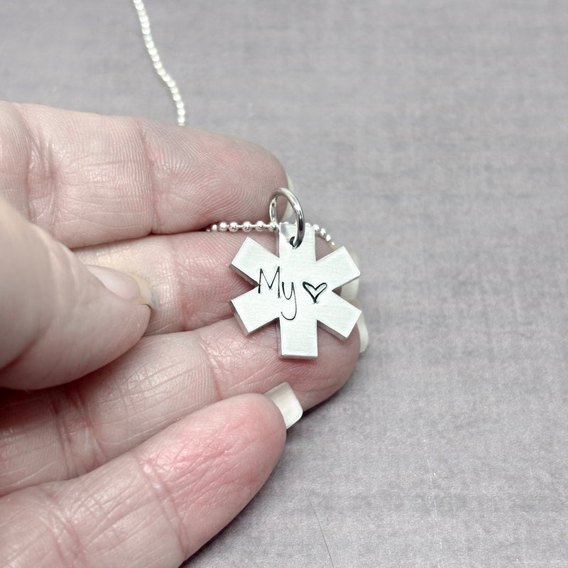 EMS necklace in hand to show size