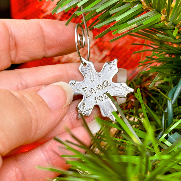 Small snowflake ornament with 1 name and date on a Christmas tree in hand to show size