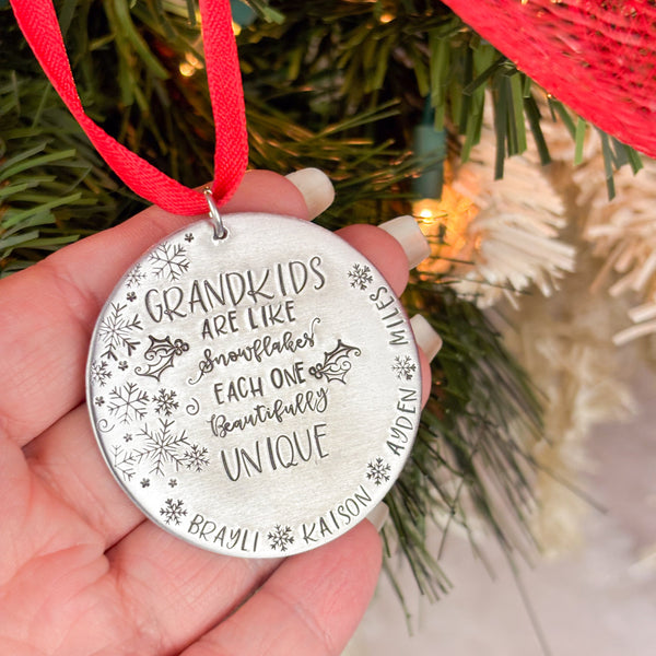 Grandchildren Christmas ornament in hand to show size