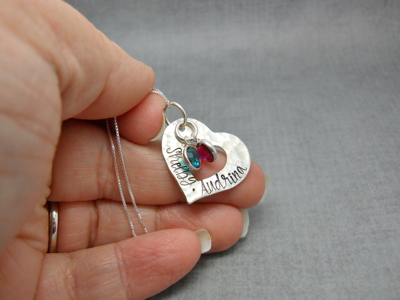 Custom Textured Sterling Silver Personalized Heart Necklace with Kids Names, held in hand